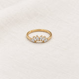Contour Gemstone Band Ring on pale grey-green linen beside a halved lime and red currants