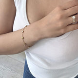 Gold Heart CZ Station Bracelet worn on the wrist