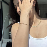 Gold Heart CZ Station Bracelet worn on the wrist