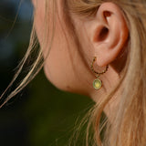 a woman wearing green jade jewelry, jade earrings