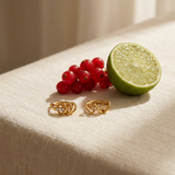 Interlocking Pave Hoops — Kinetic Gold Hoop Earrings styled still life