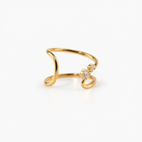 Gold ring with a small diamond on a light gray background