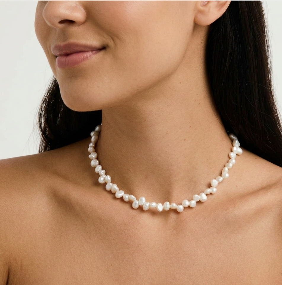 Baroque pearl necklace worn close to the neckline